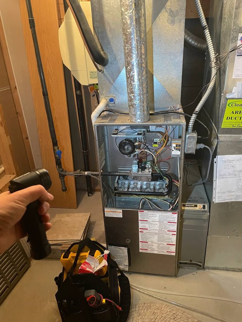 Gas furnace in a basement with the panel off
