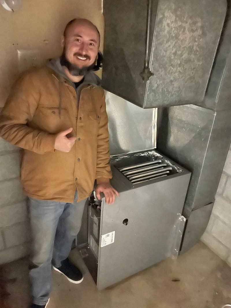 Our technician beside a new furnace installation