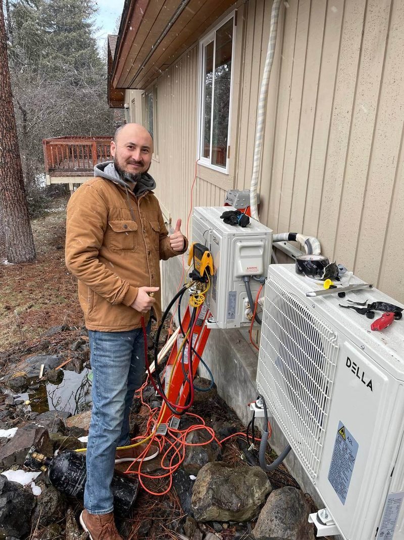 Our technician at a ductless mini-split outdoor unit